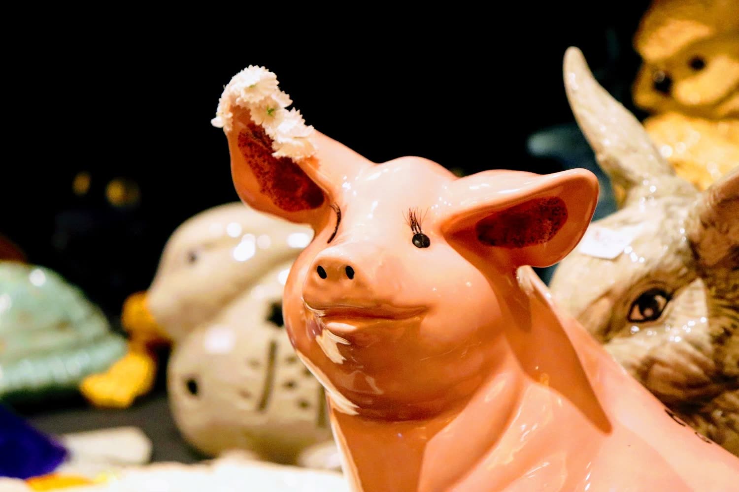 Hand-painted animal figurines at a craft show booth