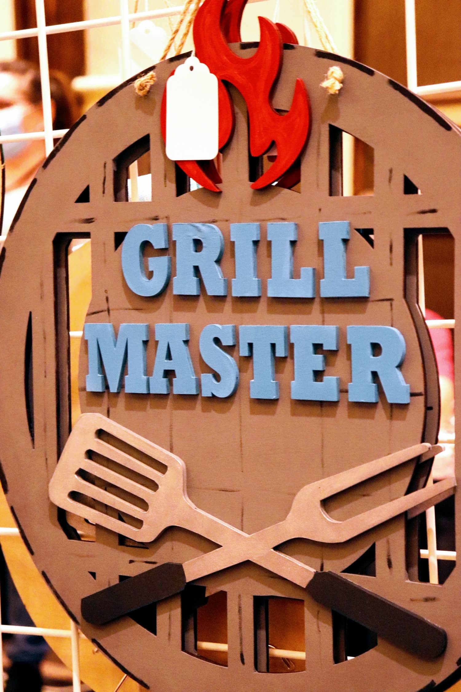 A cut-metal "Grill Master" sign made by a vendor