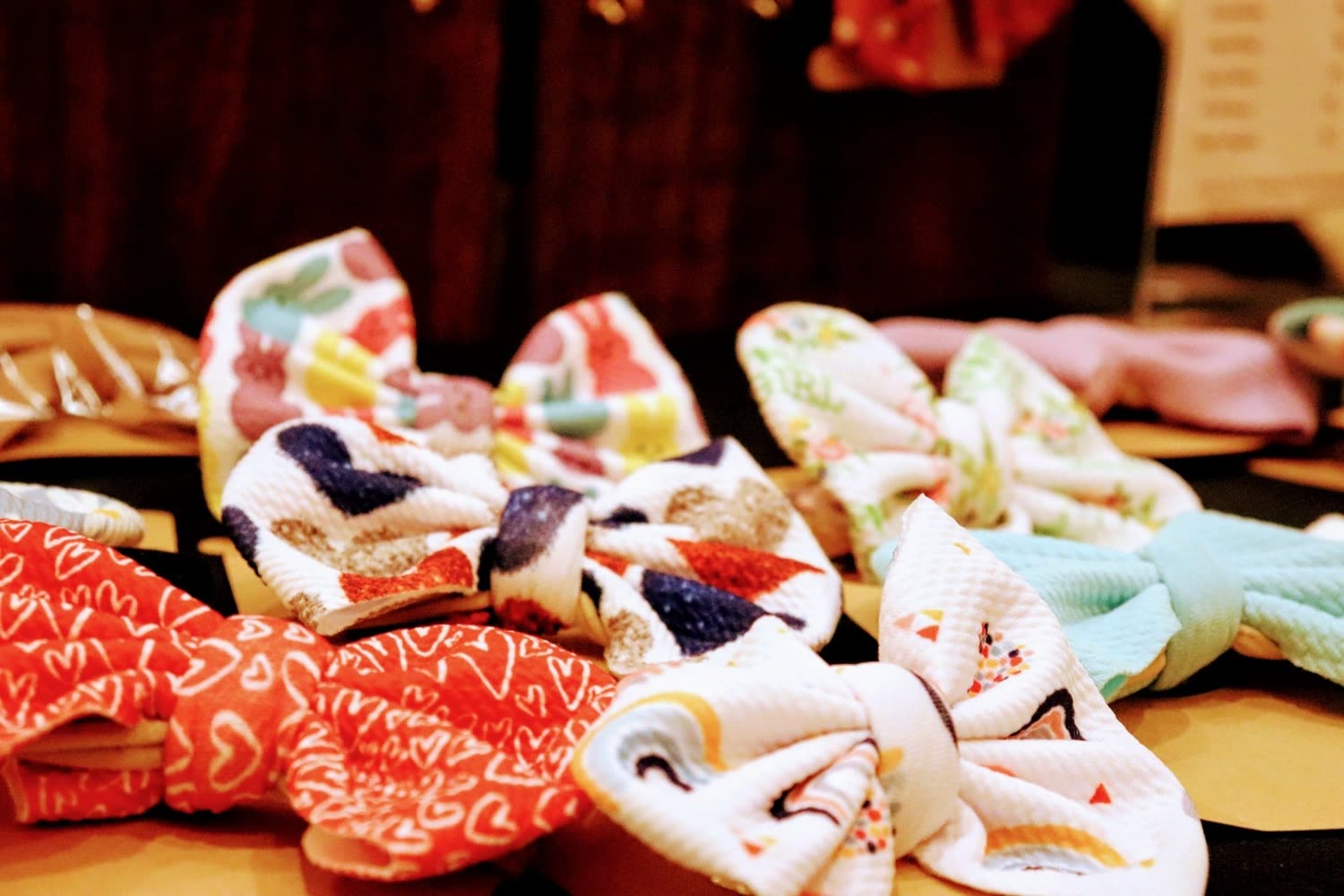 Folded handmade fabric goods laid out on a table