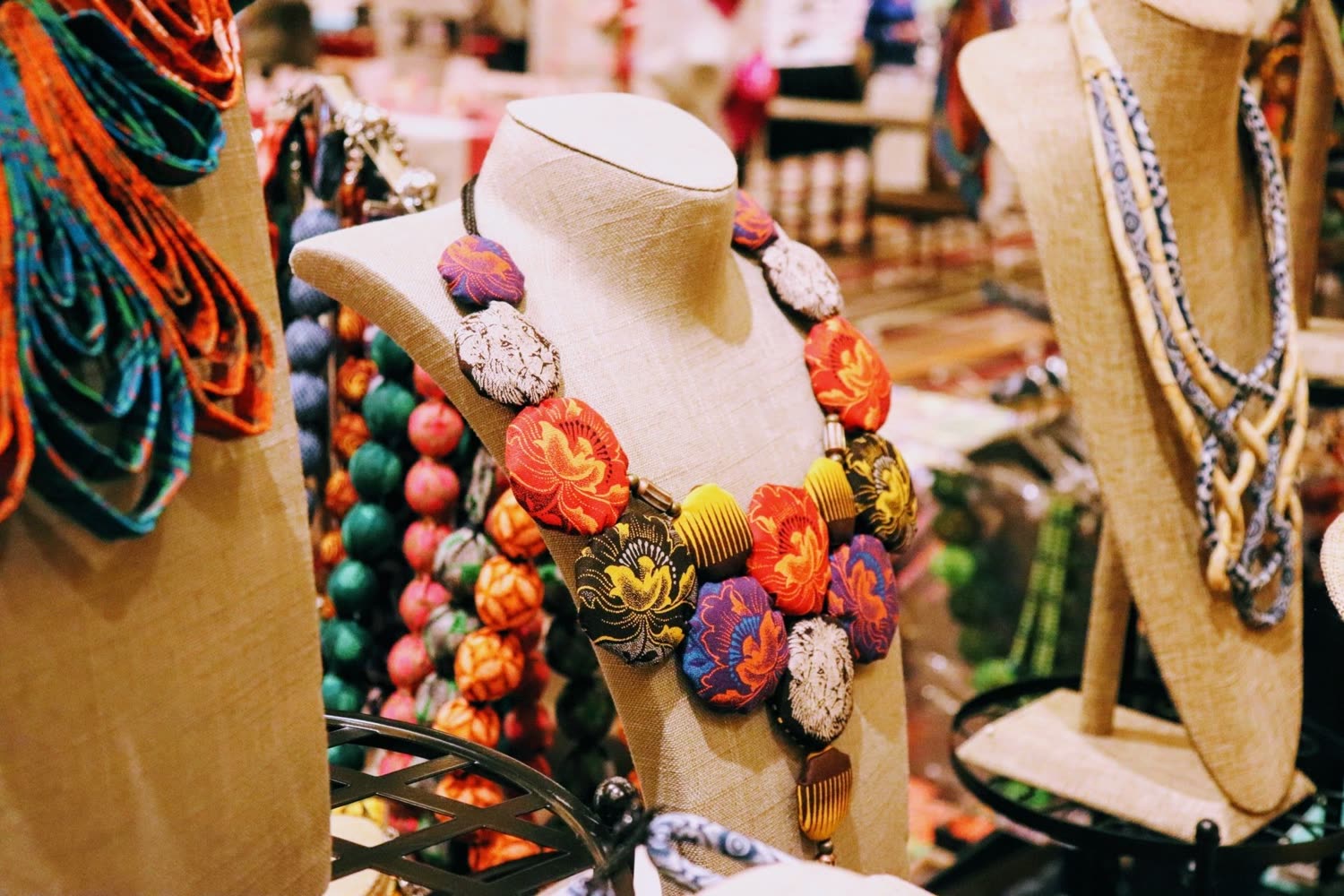Beaded statement necklaces displayed on a mannequin