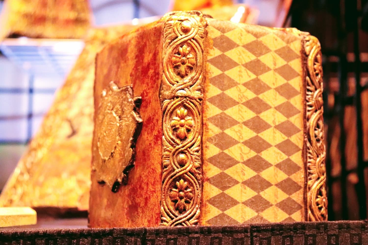 A hand-decorated keepsake box in gold and red