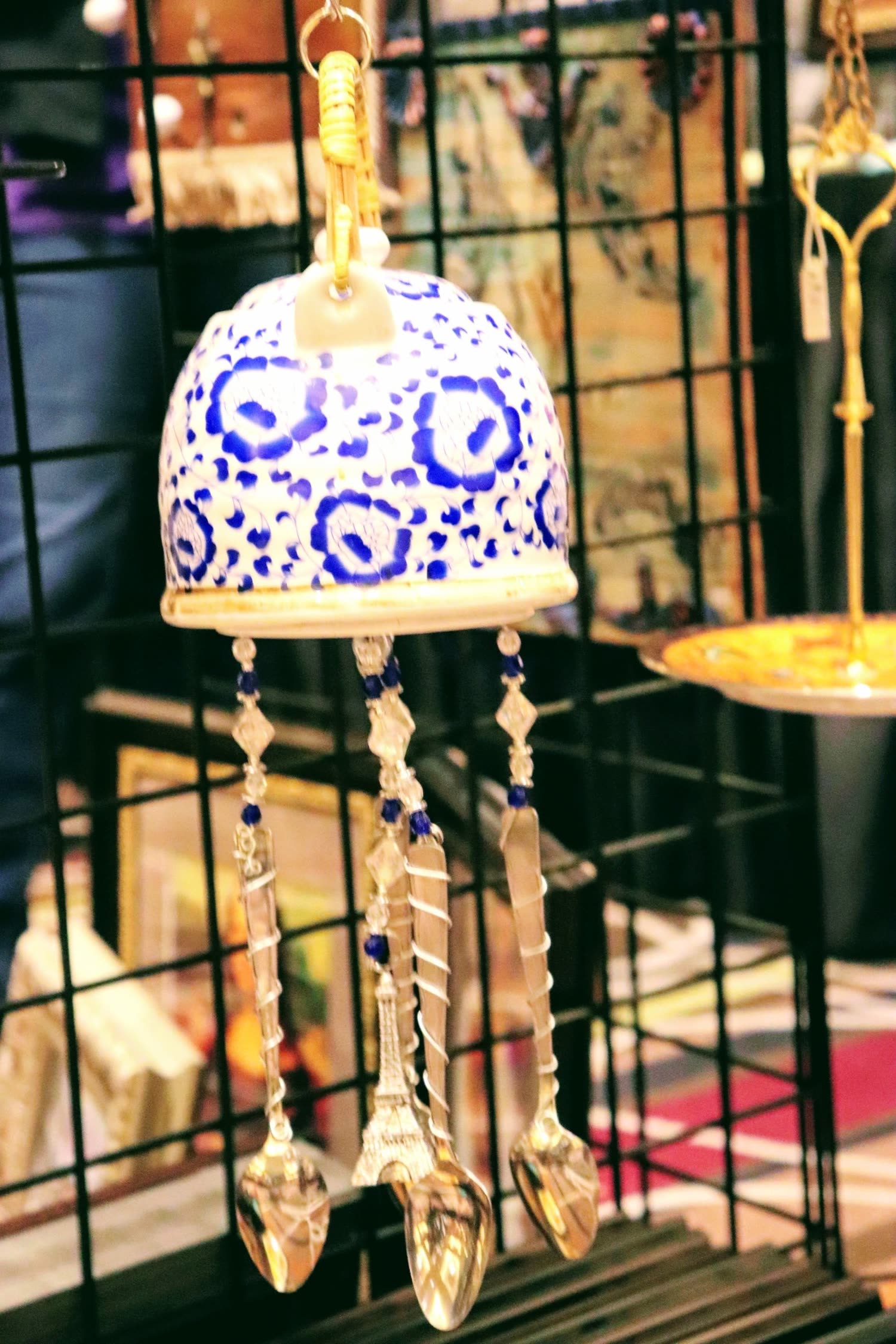 A blue and white hand-painted bell ornament